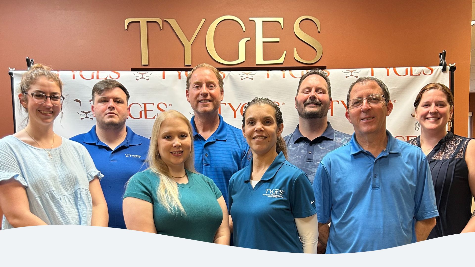 TYGES team dressed in blue to support Autism Acceptance Month